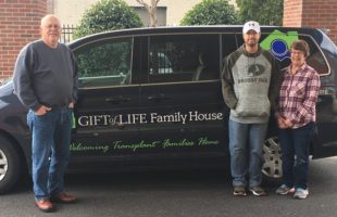 The Baker Family standing in front of the Howie's House shuttle.