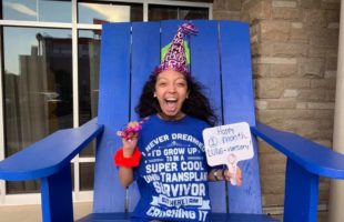 Nicole smiling on blue chair celebrating anniversary