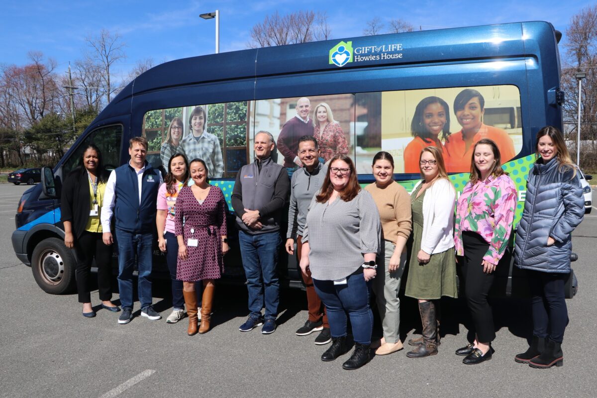 MTF Staff and Rick Hasz, CEO of Gift of Life standing in front of the Gift of Life Howie's House Shuttle.