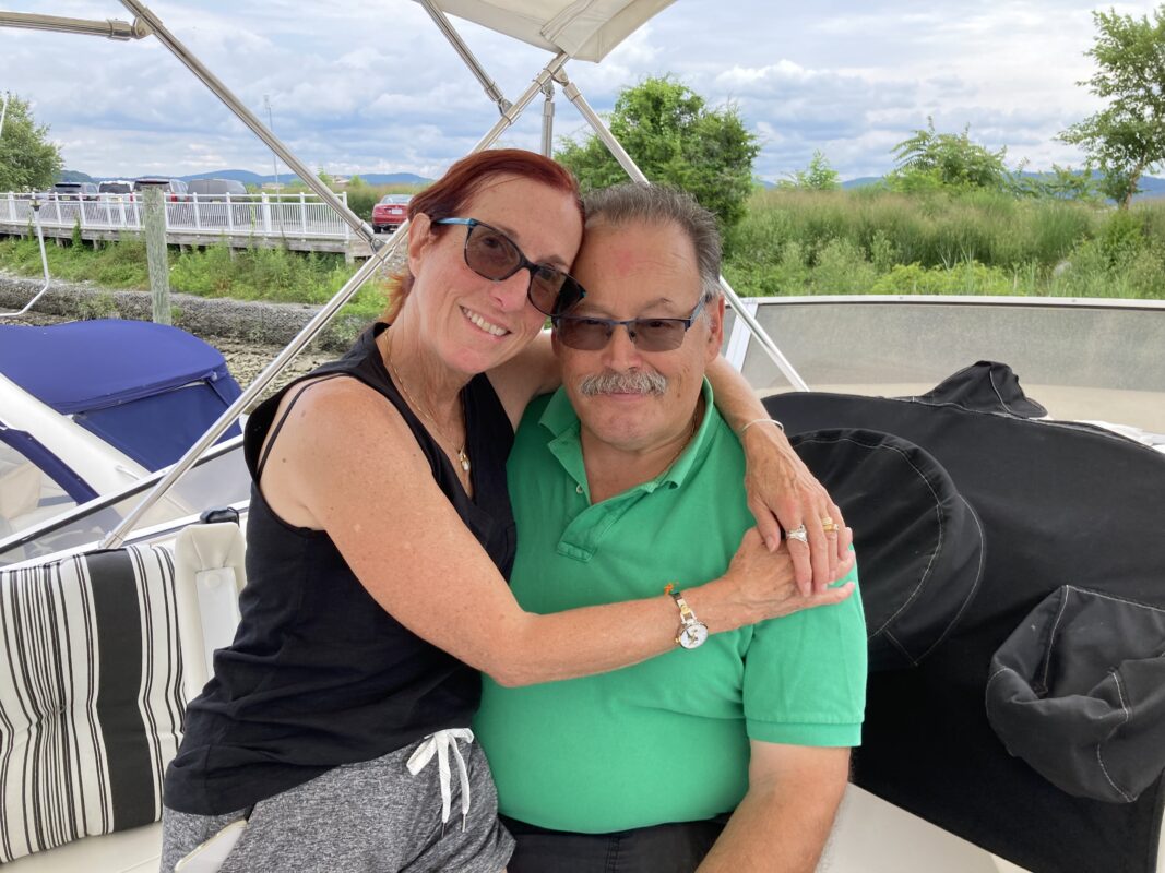 Sarita and Mark Felder sitting together on their boat. 