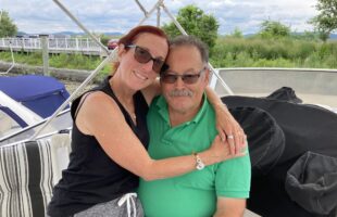 Sarita and Mark Felder sitting together on their boat.