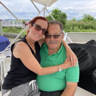 Sarita and Mark Felder sitting together on their boat.