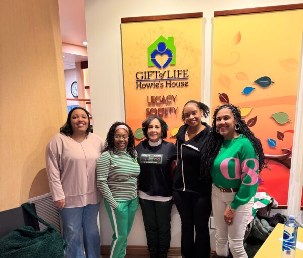Alpha Kappa Alpha Sorority members standing in the Howie's House Entrance for a photo