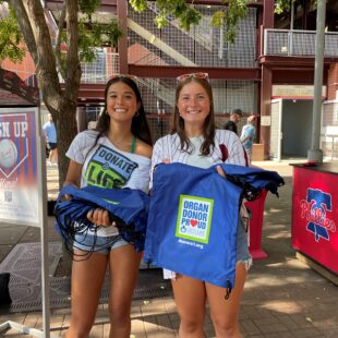 Gift of Life Volunteer Ambassadors holding organ donor proud bags
