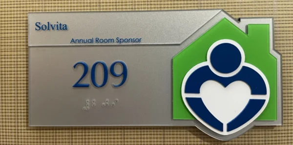 Room signage with Solvita listed as a sponsor for room 209