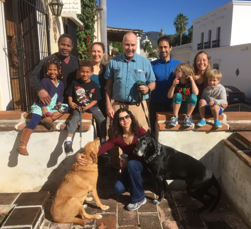 Jim pictured centered surrounded by his wife, children and grandkids and pet dog.