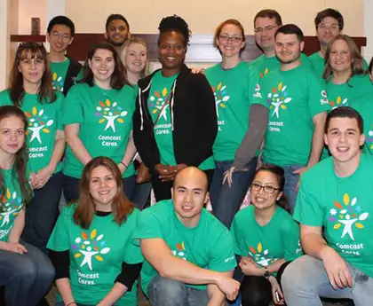 a group of employees from comcast helping howie's house